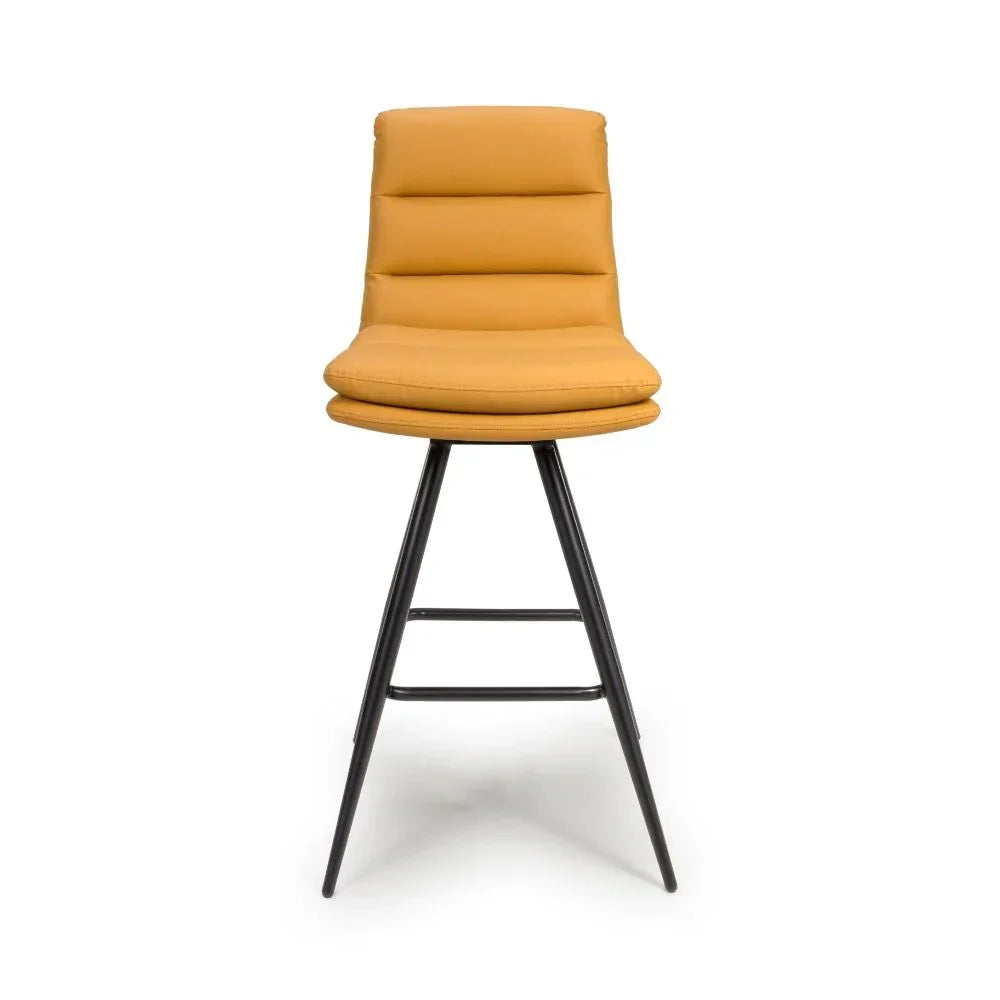 Mustard yellow bar stool with padded seat and black metal legs, front view