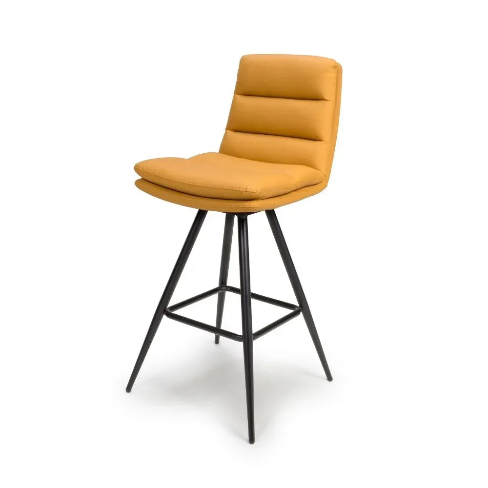 Mustard yellow bar stool with padded seat and backrest, black metal legs, modern design