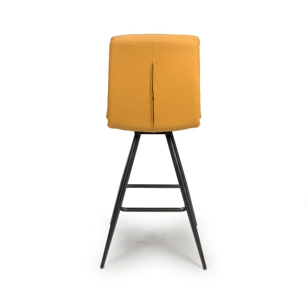 Yellow upholstered bar stool with black metal legs, rear view