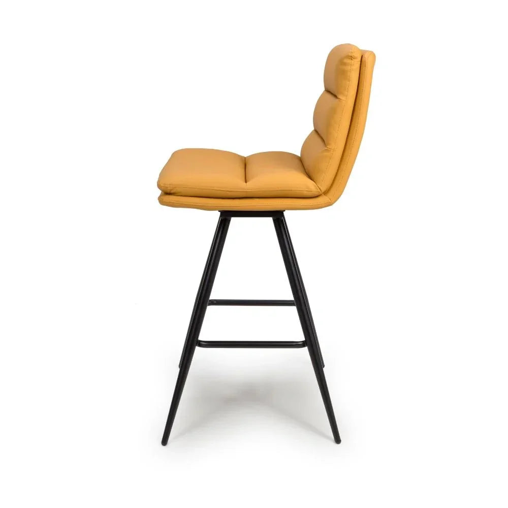 Mustard yellow cushioned bar stool with black metal legs, side profile view