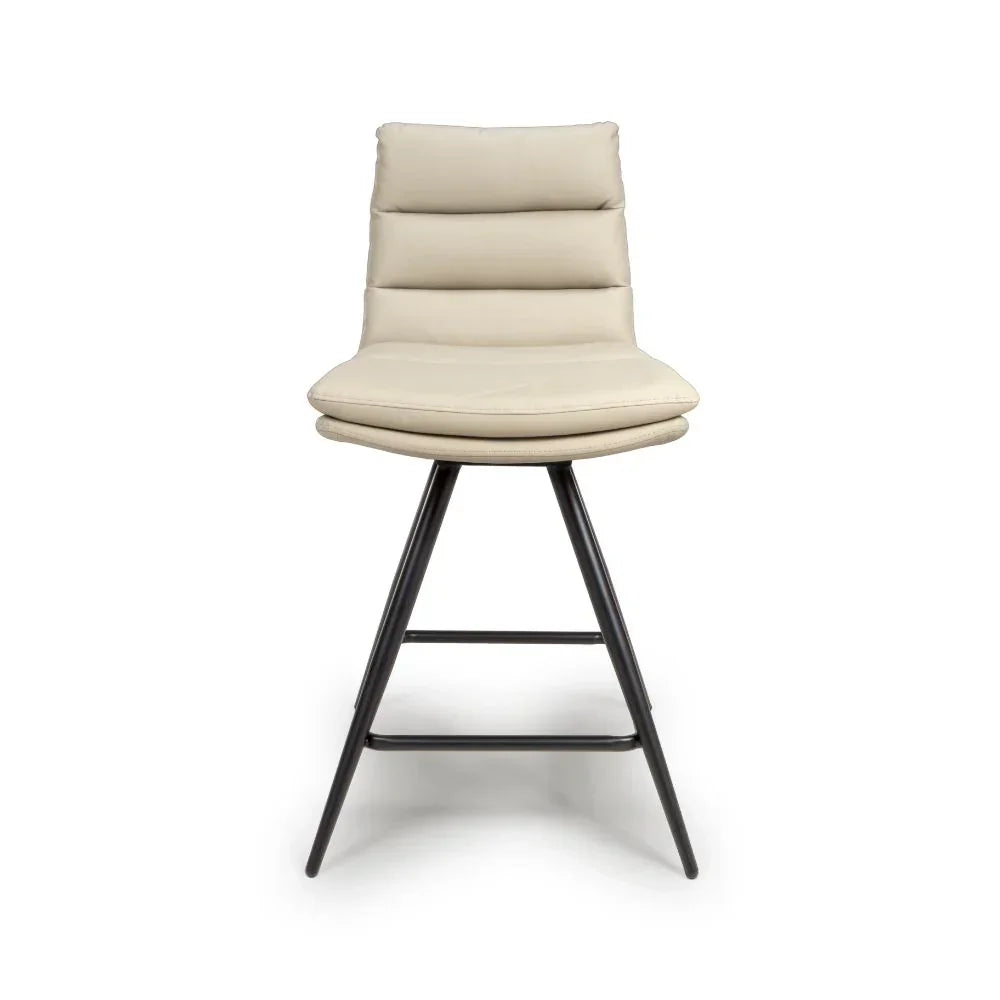 Beige leather bar stool with padded seat and metal legs, front view