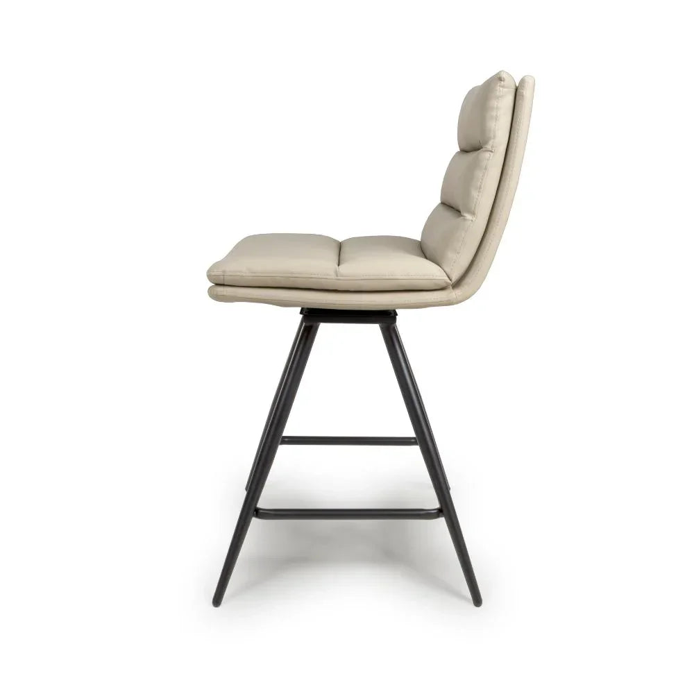 Beige padded bar stool with black metal legs, side view