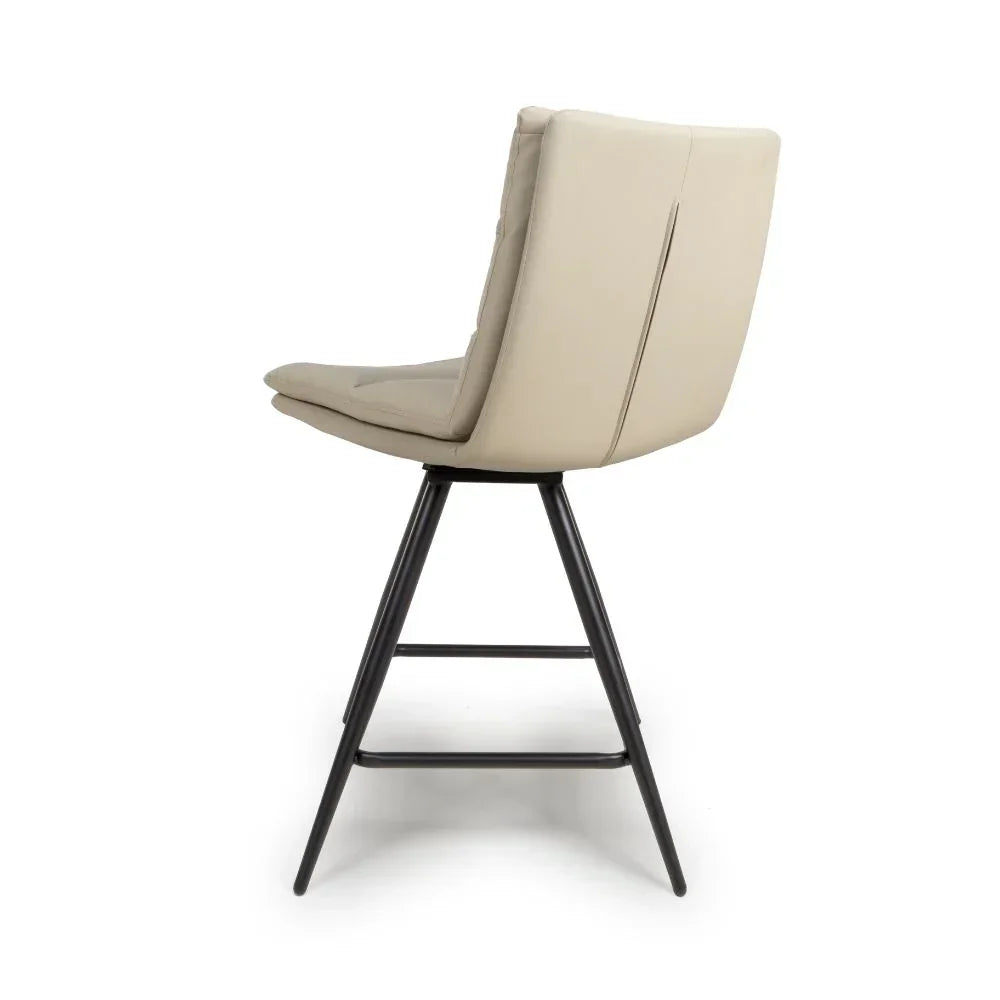 Beige leather bar stool with black metal legs, side view