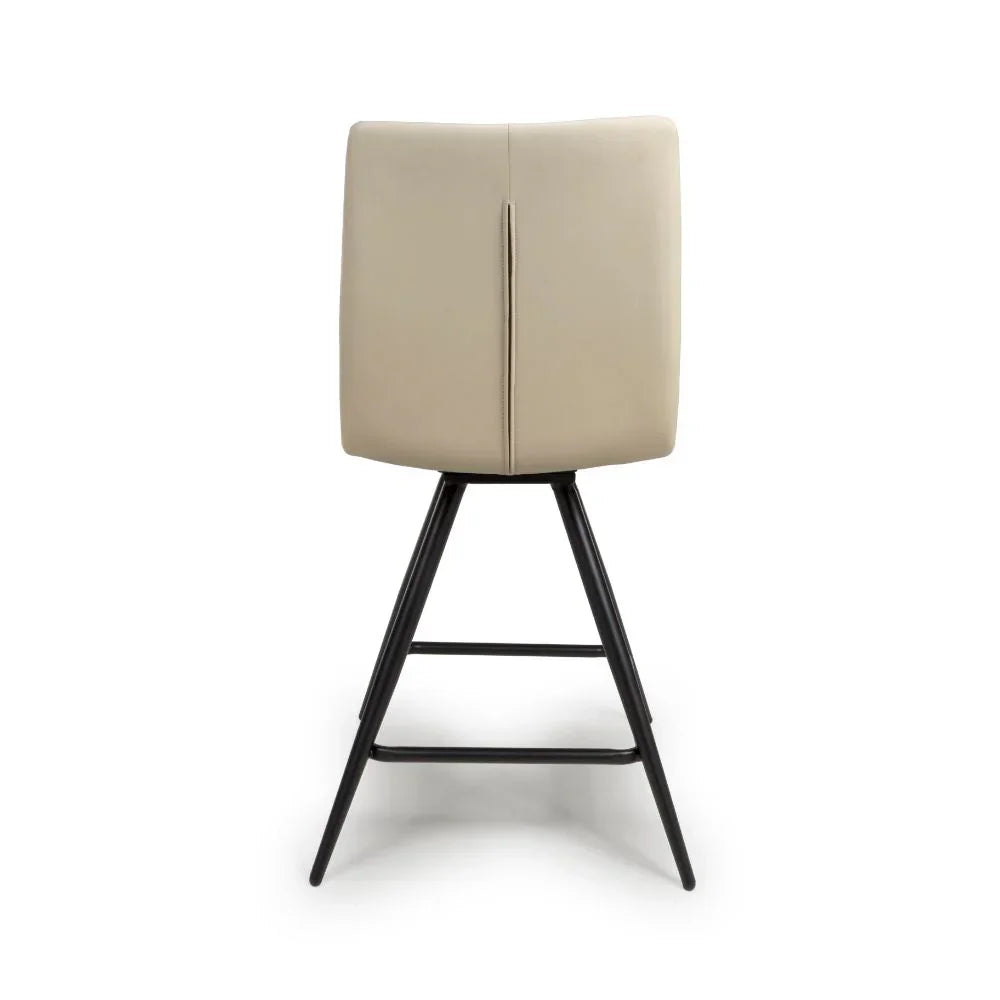 Beige leather bar stool with black metal legs shown from the back