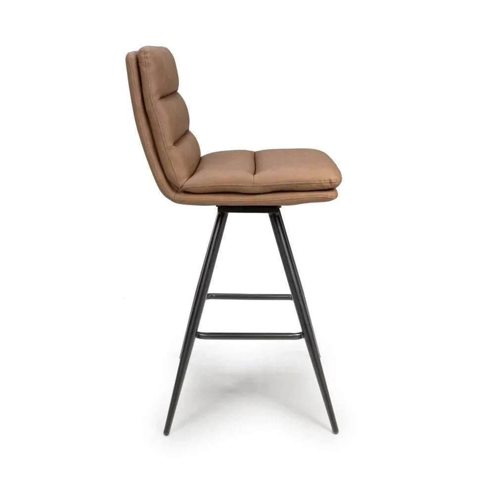 Tan padded bar stool with metal legs, side view showing cushioned seat and backrest