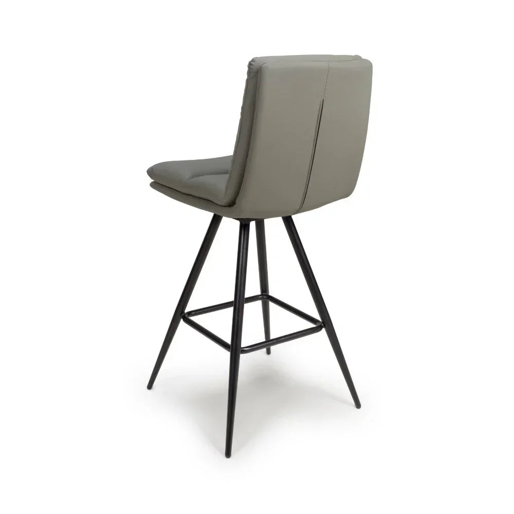 Taupe bar stool with padded seat, black legs, low backrest shown from rear angle