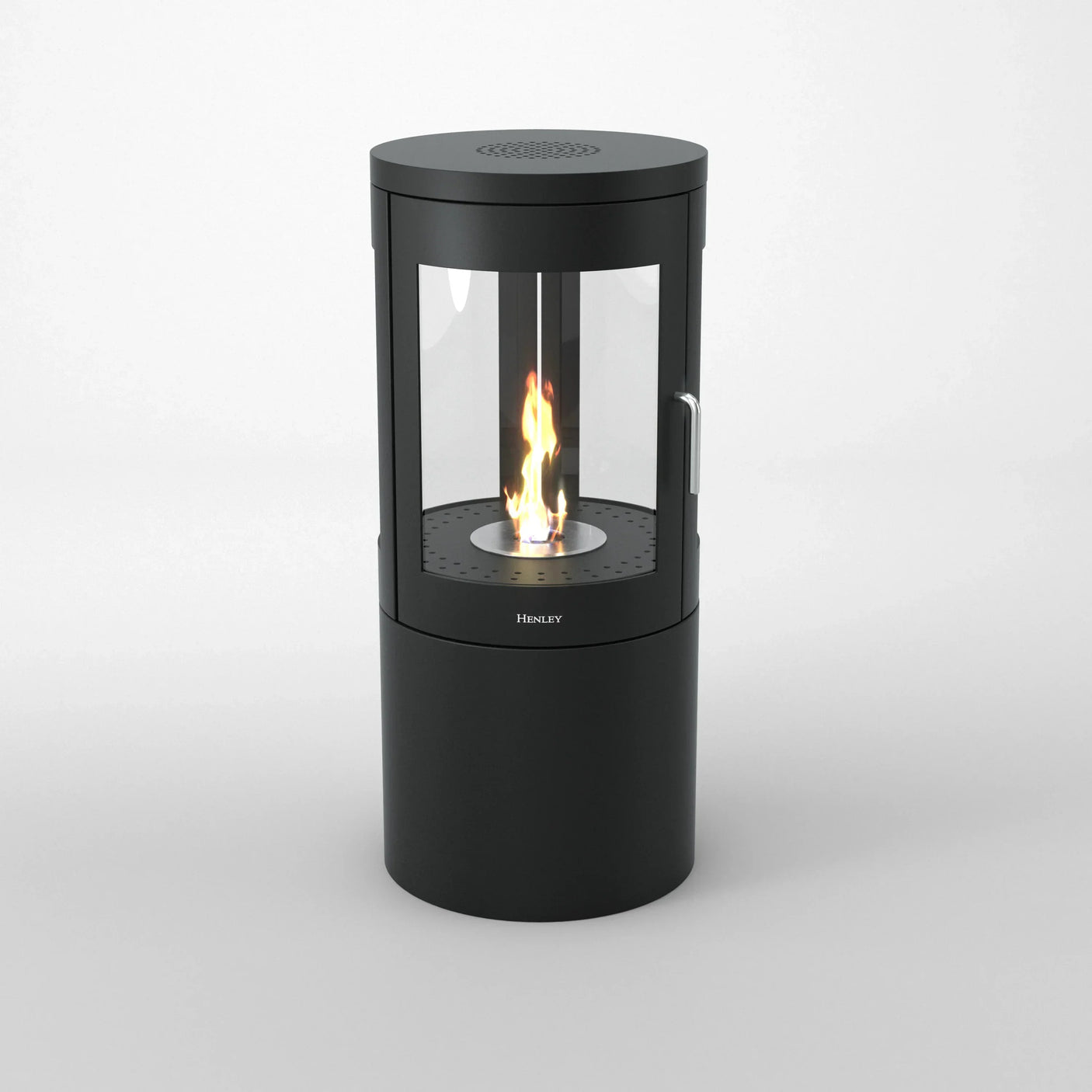 Black cylindrical bioethanol stove with glass panels and visible flame on white background