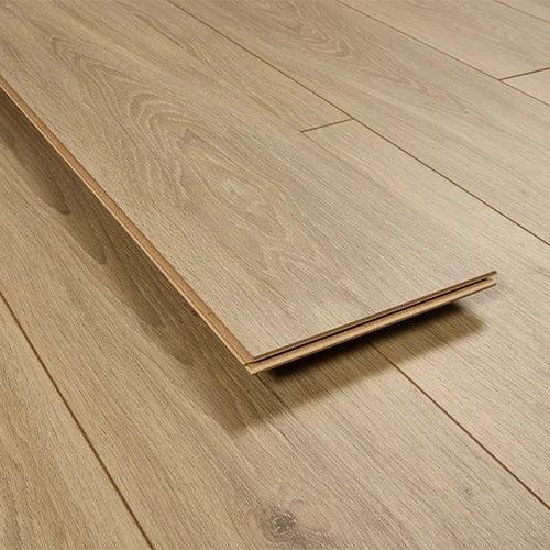 Natural oak laminate flooring planks arranged on floor, close-up of wood grain texture