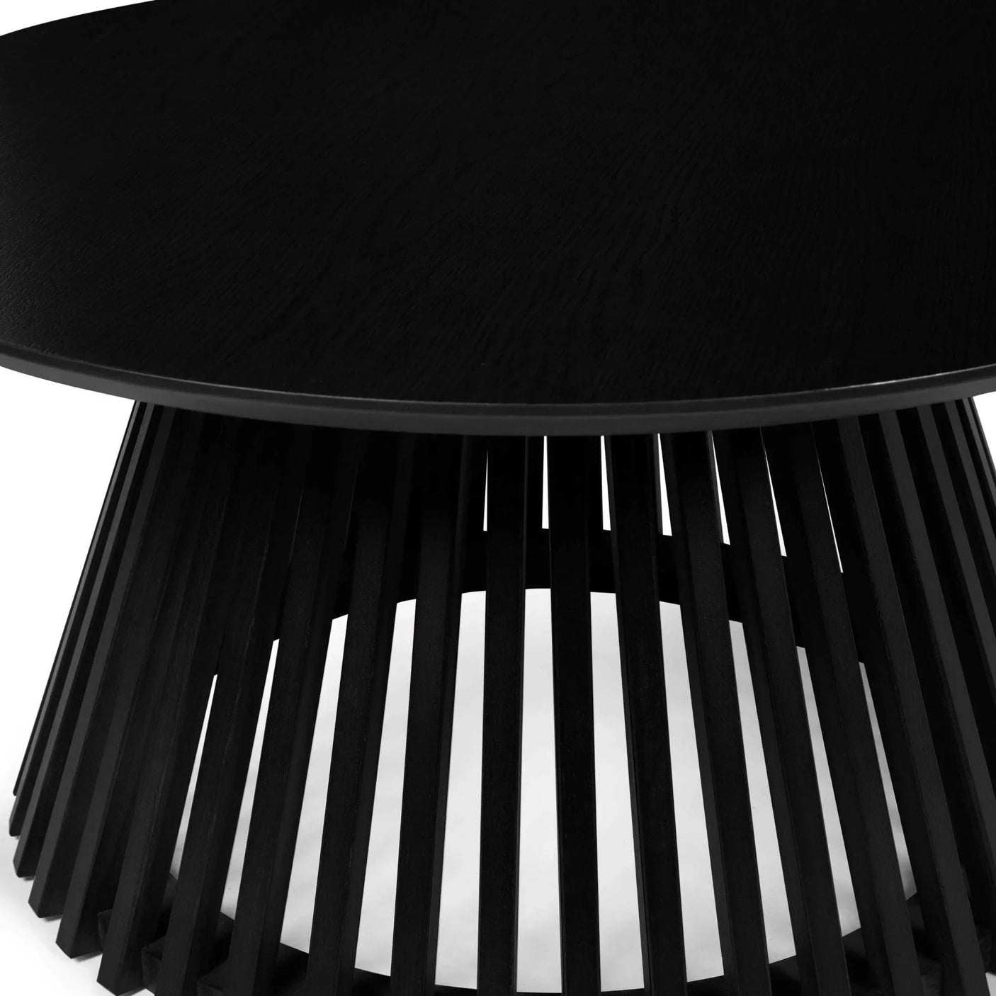 Round black coffee table with slatted wood base and smooth top, close-up view