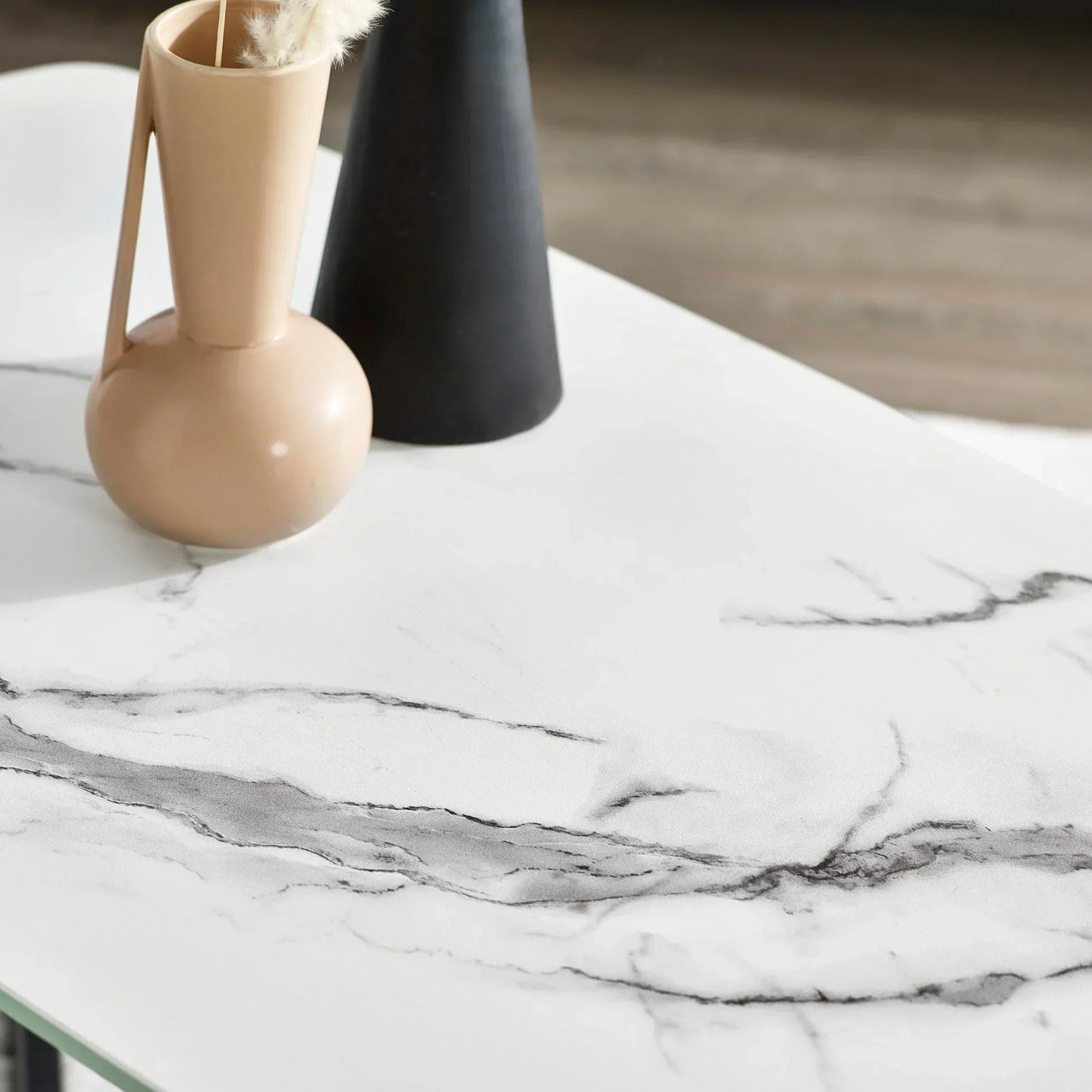 White marble coffee table surface with decorative beige and black vases