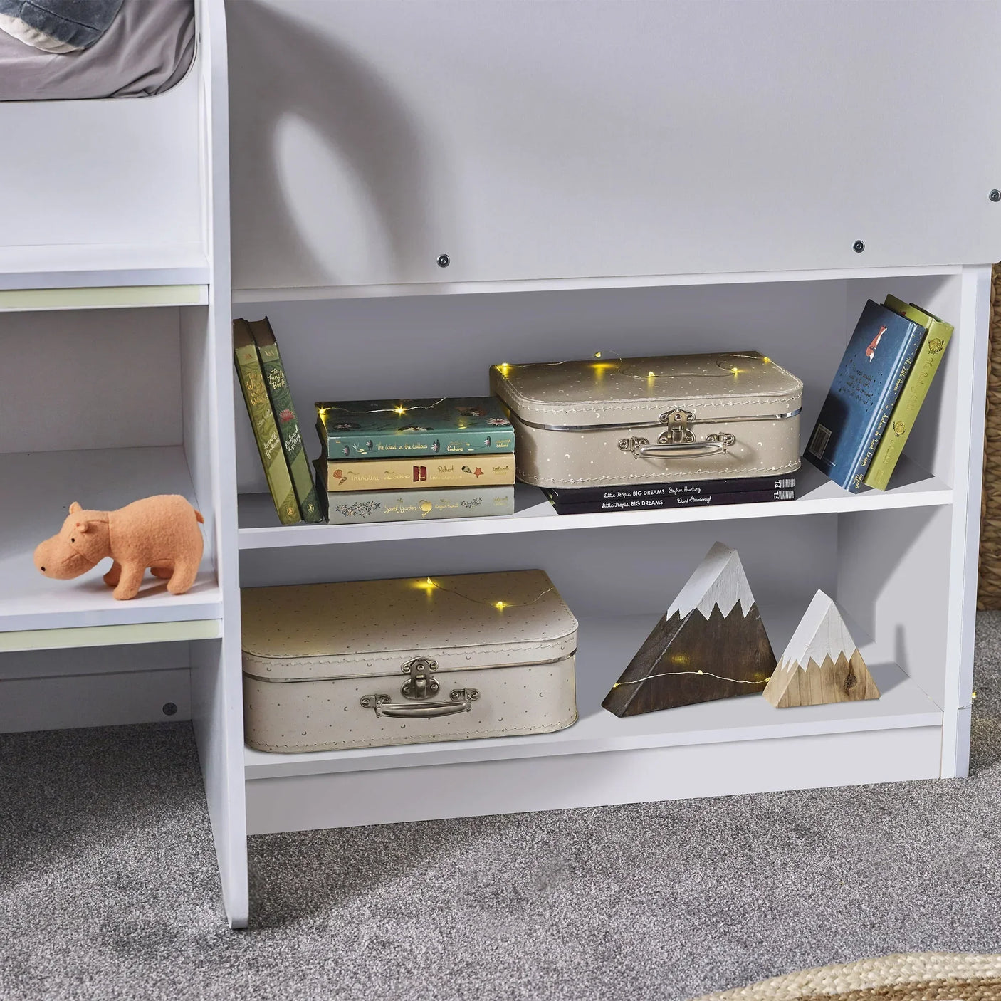 white midsleeper bed with built-in shelves, books, storage boxes and decorative accents
