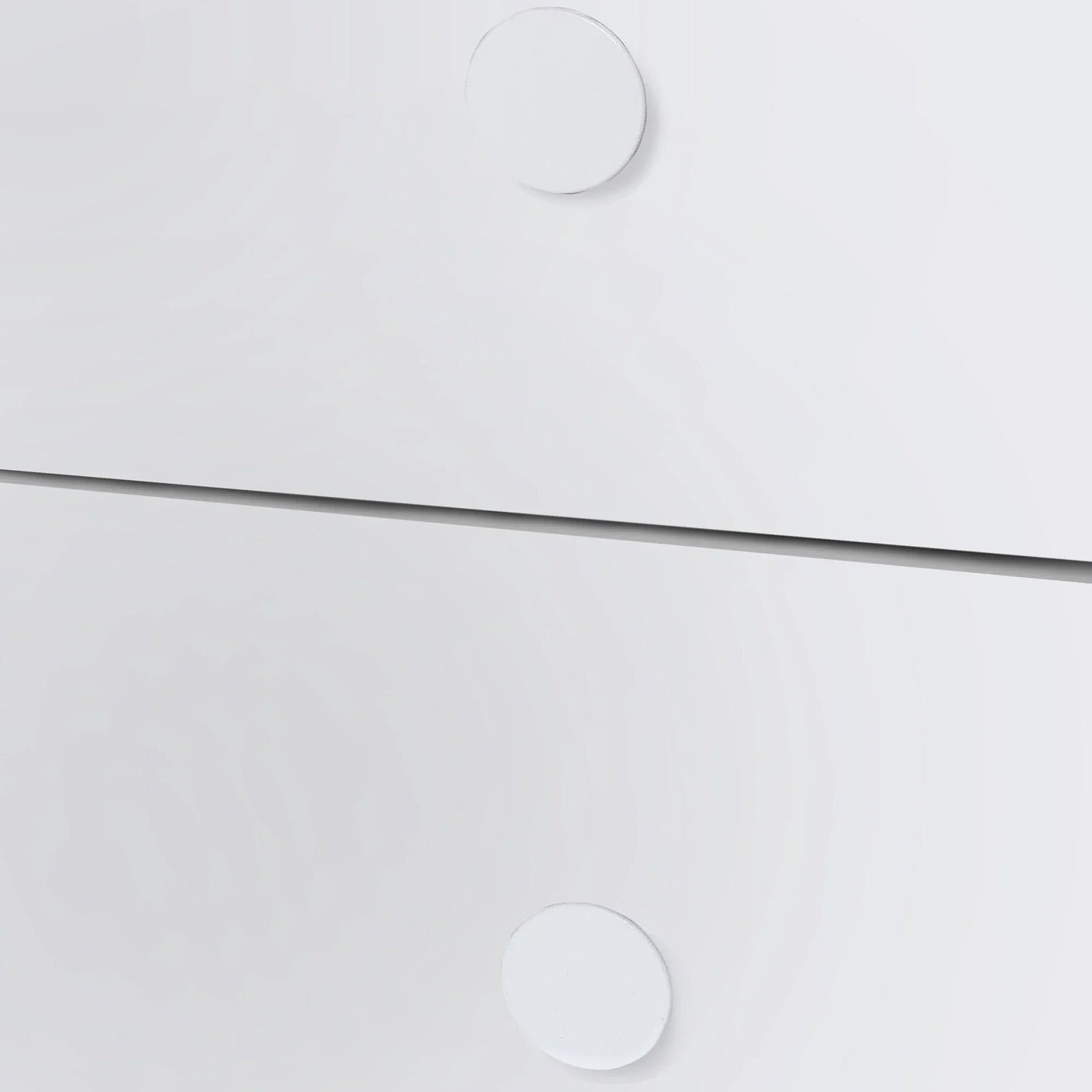 Closeup of white midsleeper bed drawers with round handles, modern furniture detail