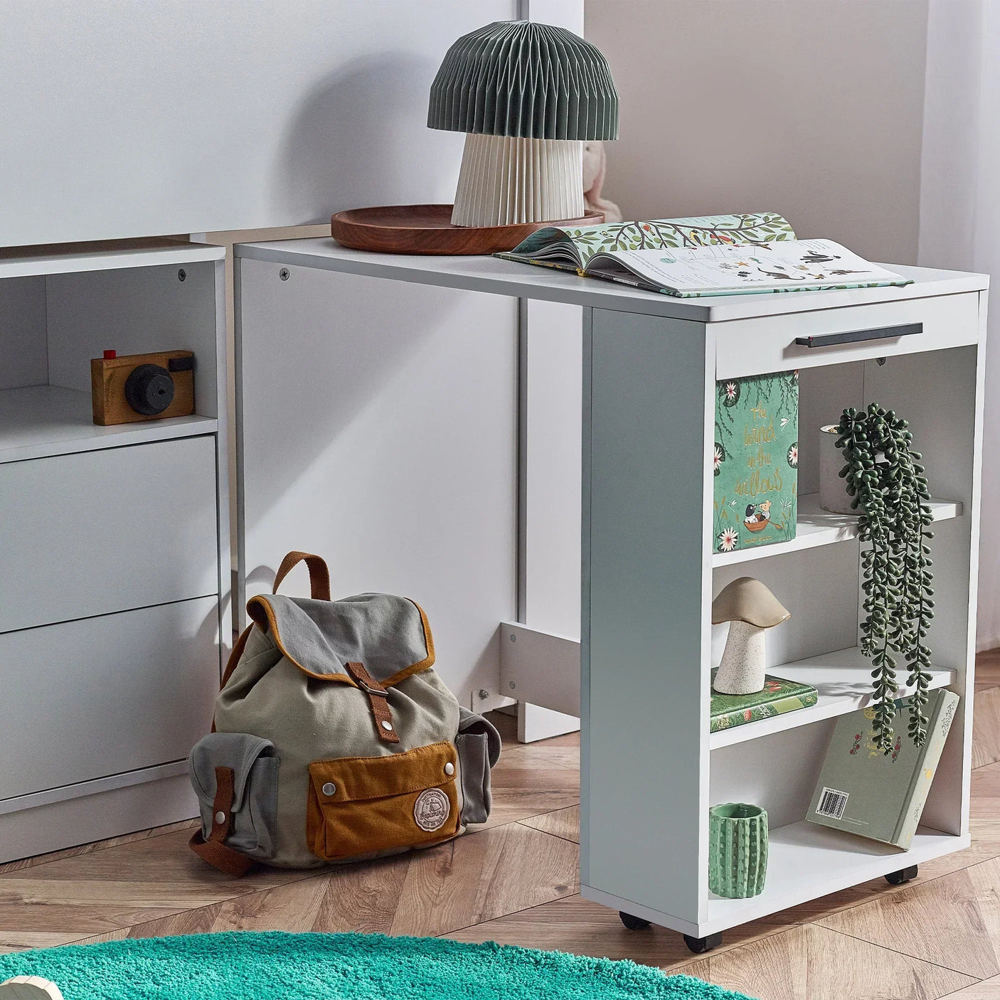 White midsleeper bed with pull-out desk, open shelving and storage in modern kids room