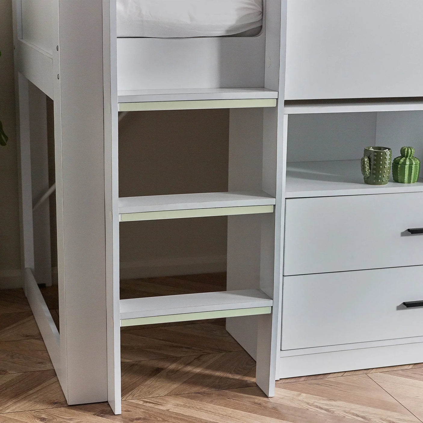 White midsleeper bed ladder and drawers with shelf accessories on wood herringbone floor