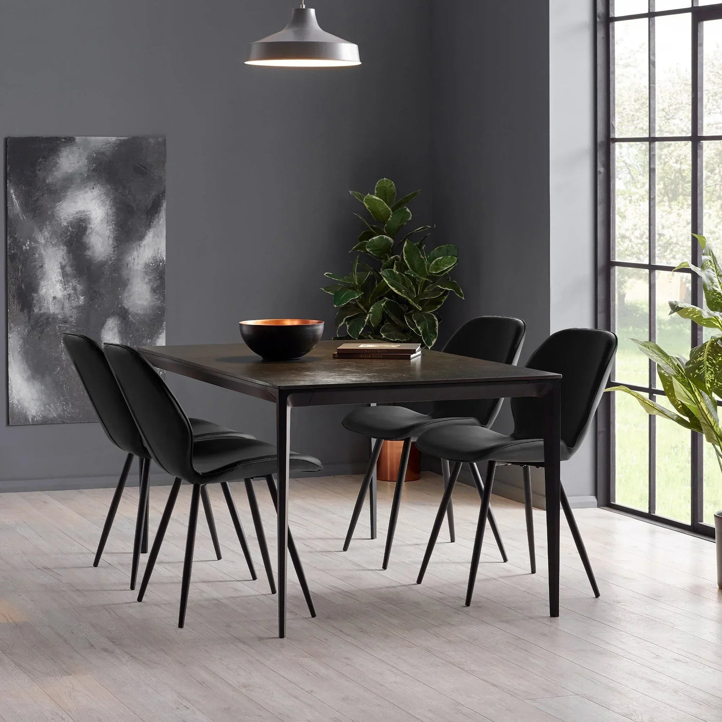 Black Otto dining chairs around dark rectangular table in modern dining room