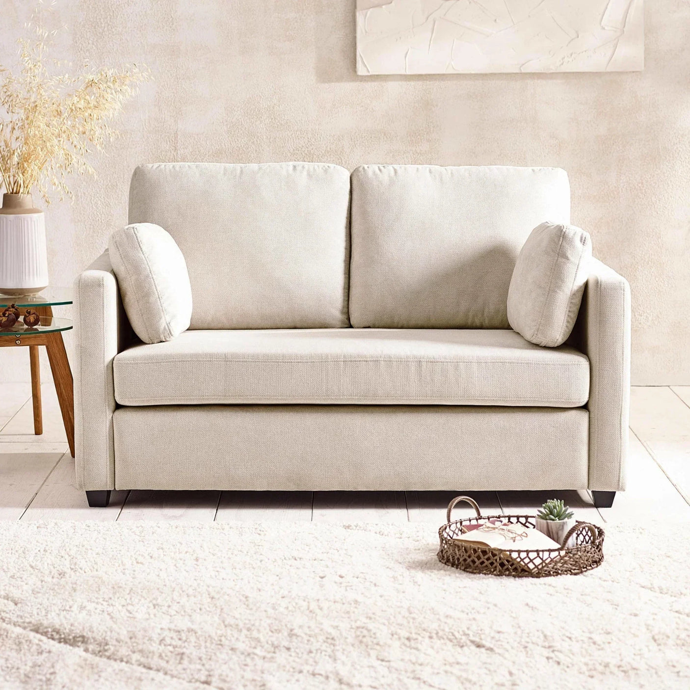 Cream fabric sofa with side cushions in a modern living room setting