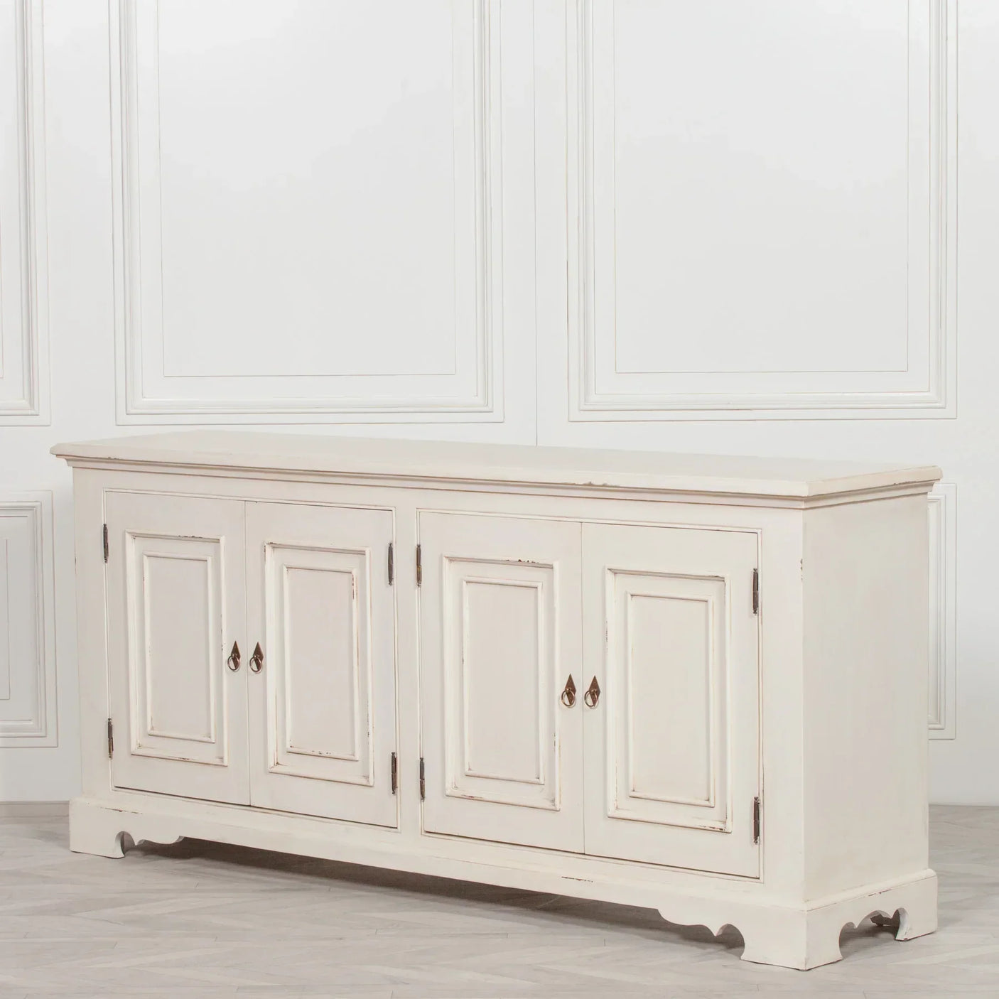 Cream painted wooden sideboard with four paneled doors and vintage metal handles