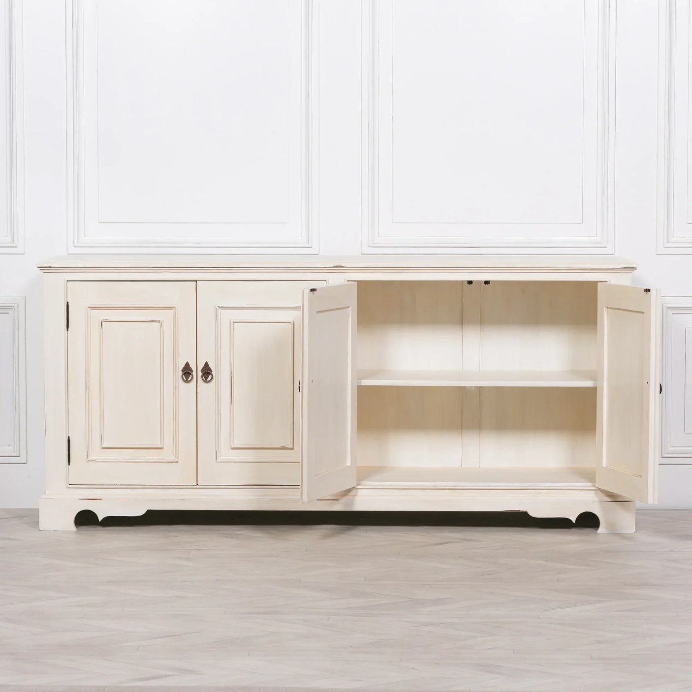Cream painted sideboard cabinet with paneled doors, one open to show interior shelving
