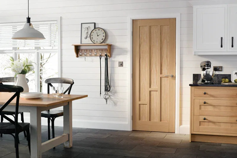 Oak interior door with vertical panels in modern kitchen dining room setting