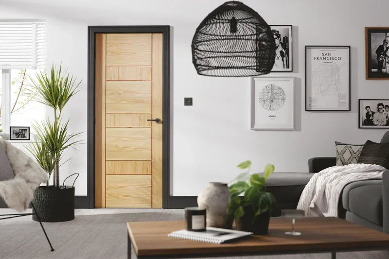 Oak interior door with horizontal panels in modern living room with grey sofa and wall art