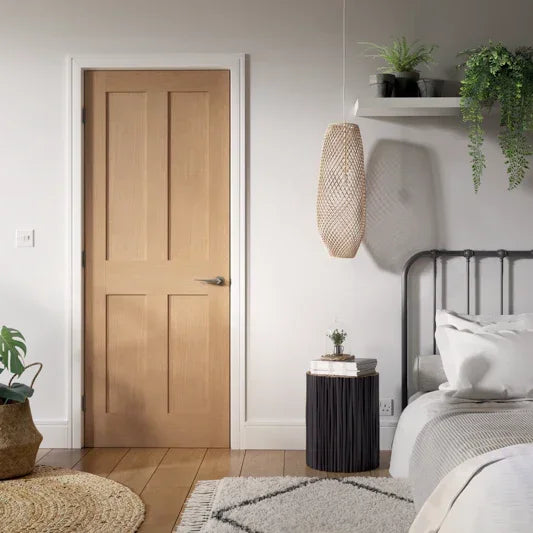 Oak door with modern handle in bedroom, metal bed frame, indoor plants, neutral decor