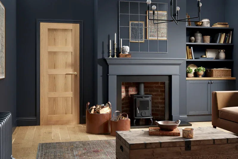 Oak shaker 4 panel door in modern living room with wood floor and dark blue walls