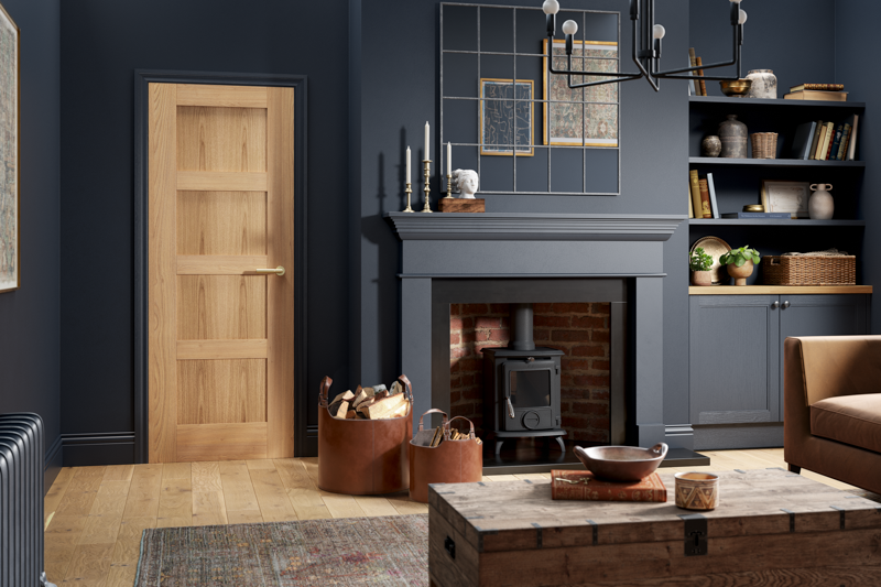 Oak Shaker 4 panel interior door in modern living room with dark walls and wood floor