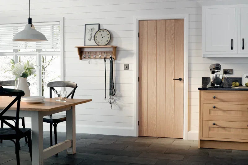 Oak Wexford internal door in modern kitchen with white walls and light wood cabinetry