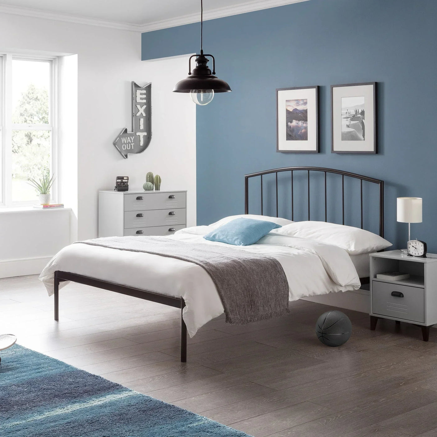 Onyx bed frame with white bedding and metal headboard in modern blue and grey bedroom