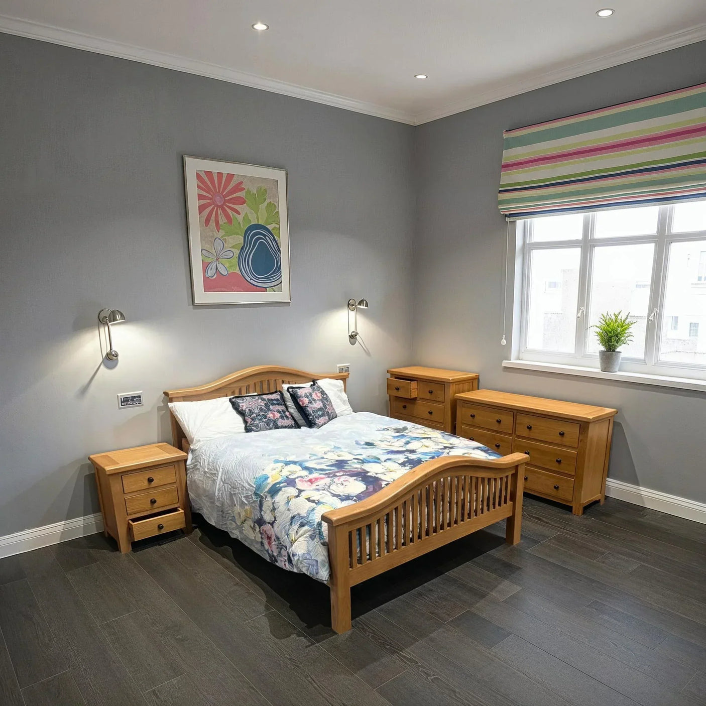 Oak bedroom furniture set with bed, two bedside tables and two chests in modern room