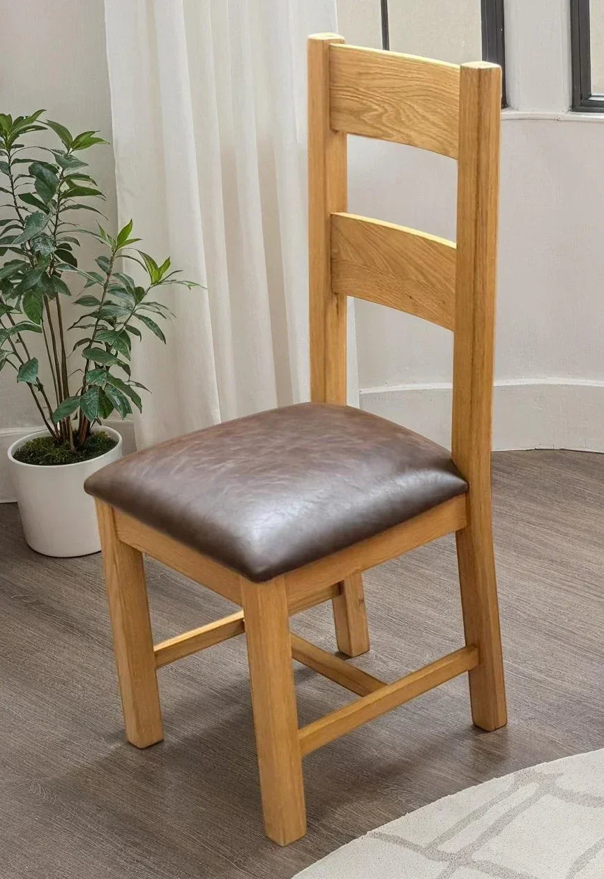 Wooden dining chair with brown PU seat cushion in modern room setting