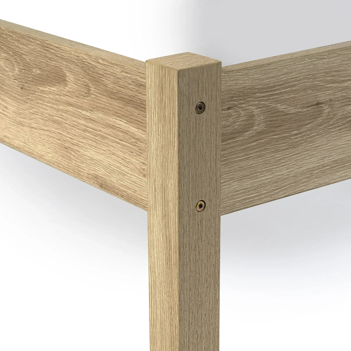 Close up of oak rattan double bed frame corner showing wood grain and joinery detail