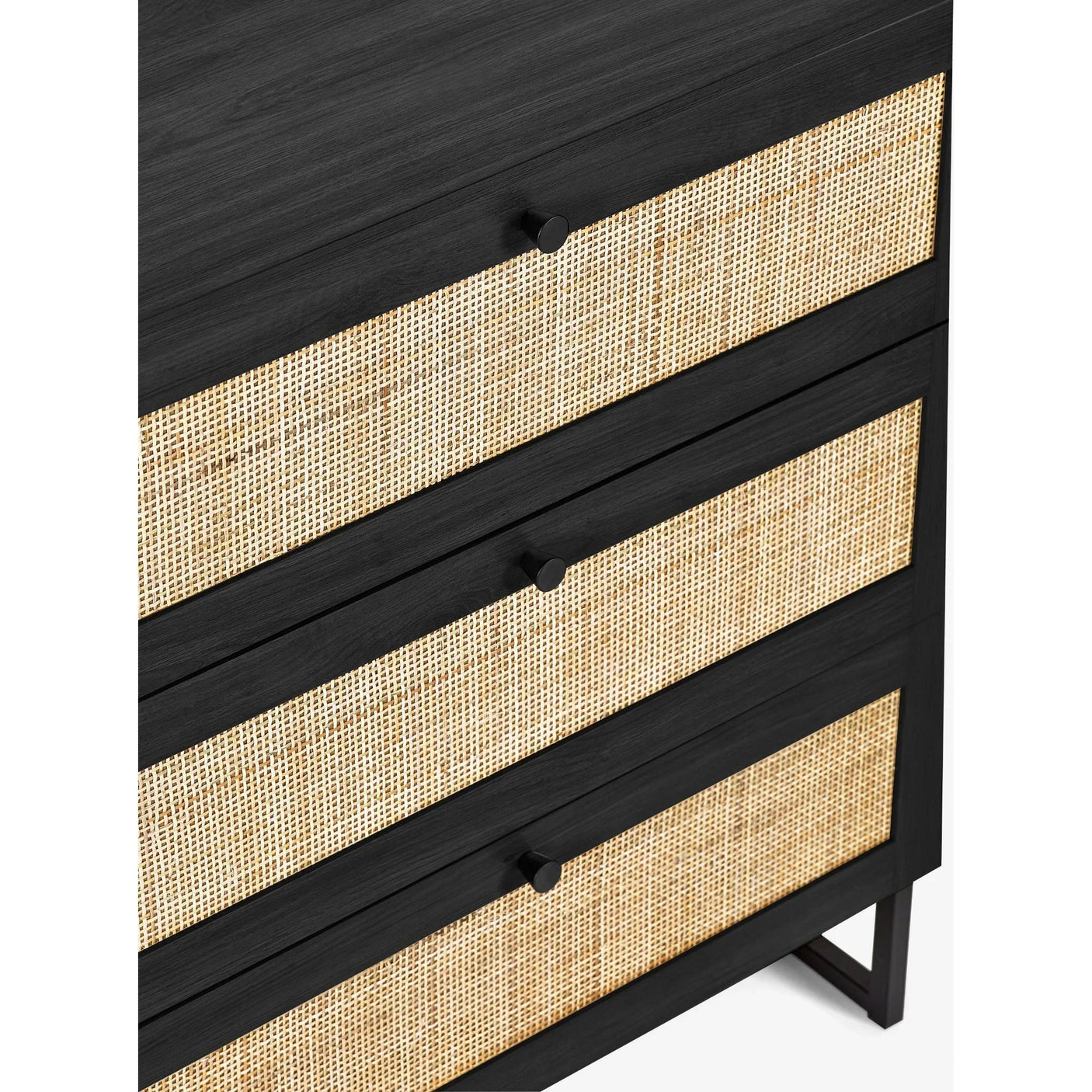 Black three drawer chest with rattan fronts and round black handles, close-up detail