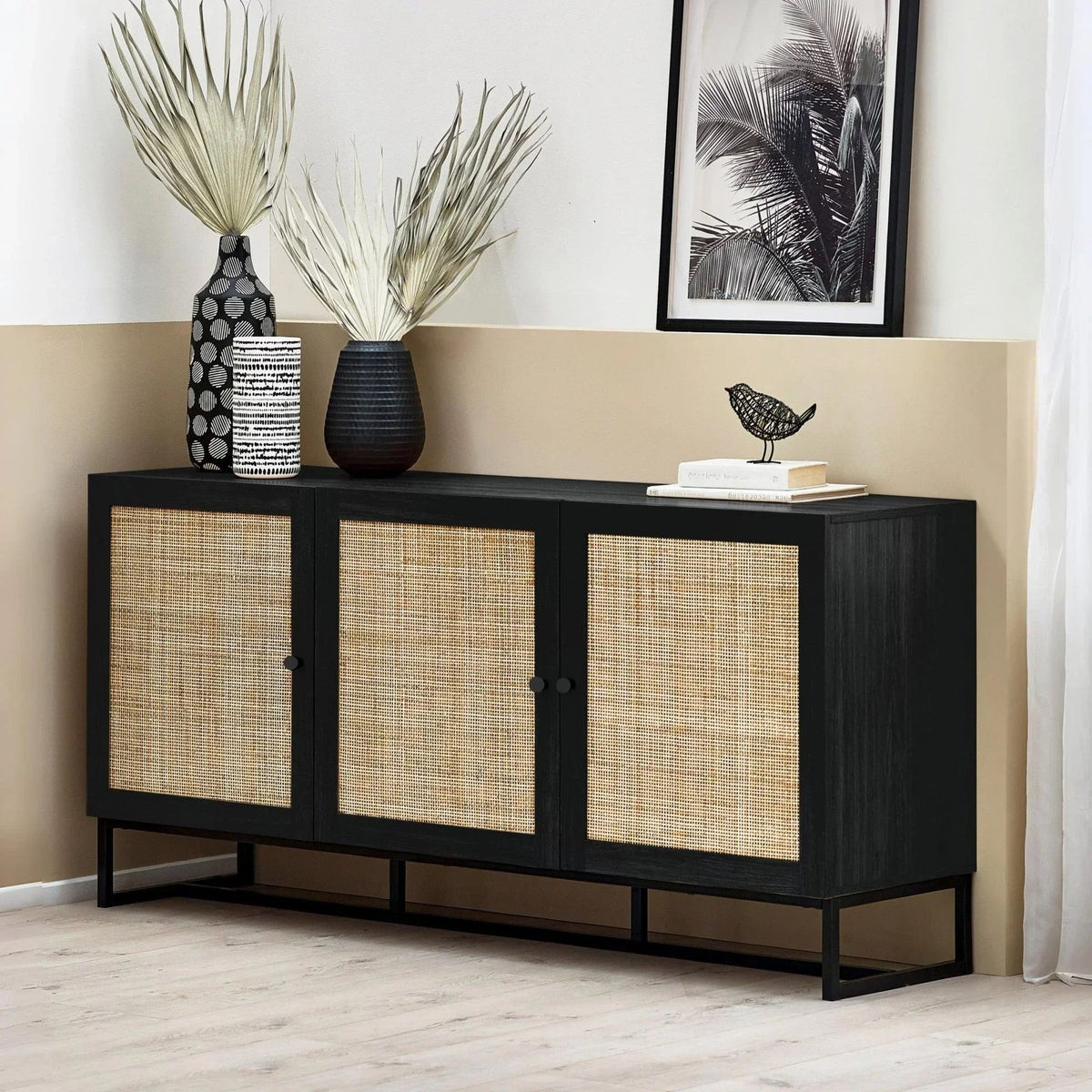 Black sideboard with rattan cane door fronts, roomset with vases and framed art