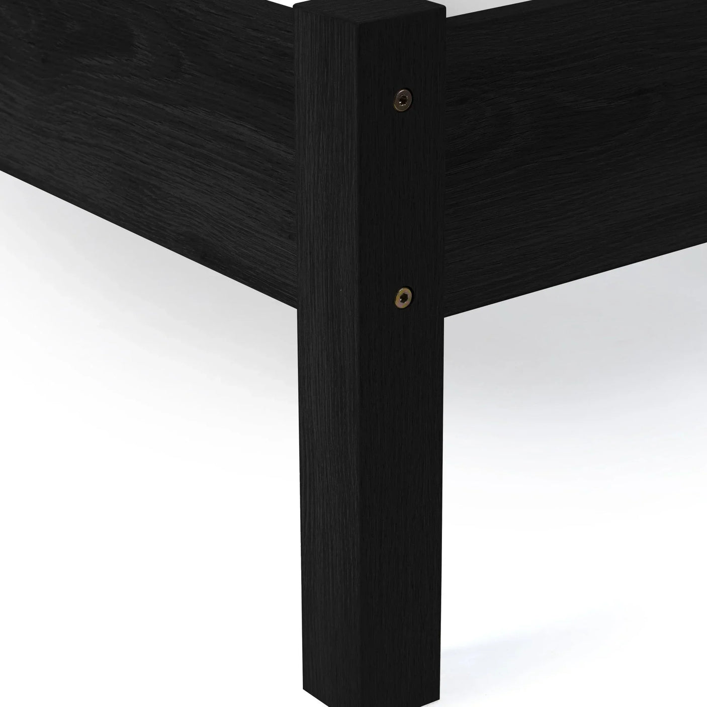 Black rattan double bed corner with visible wood grain and sturdy leg detail