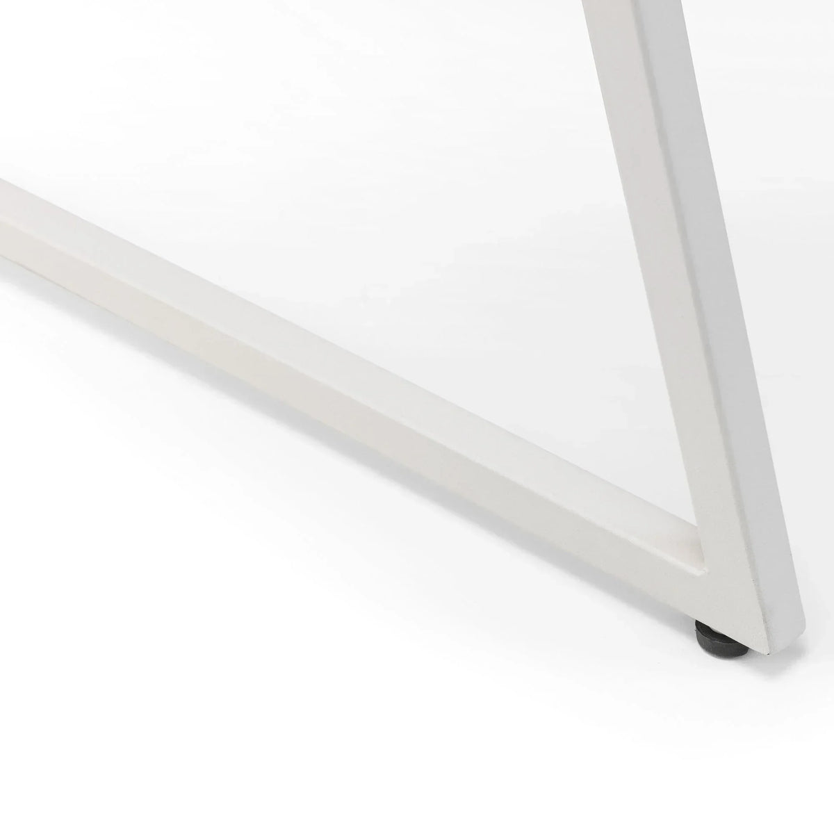 White metal table leg with angled frame detail on smooth surface