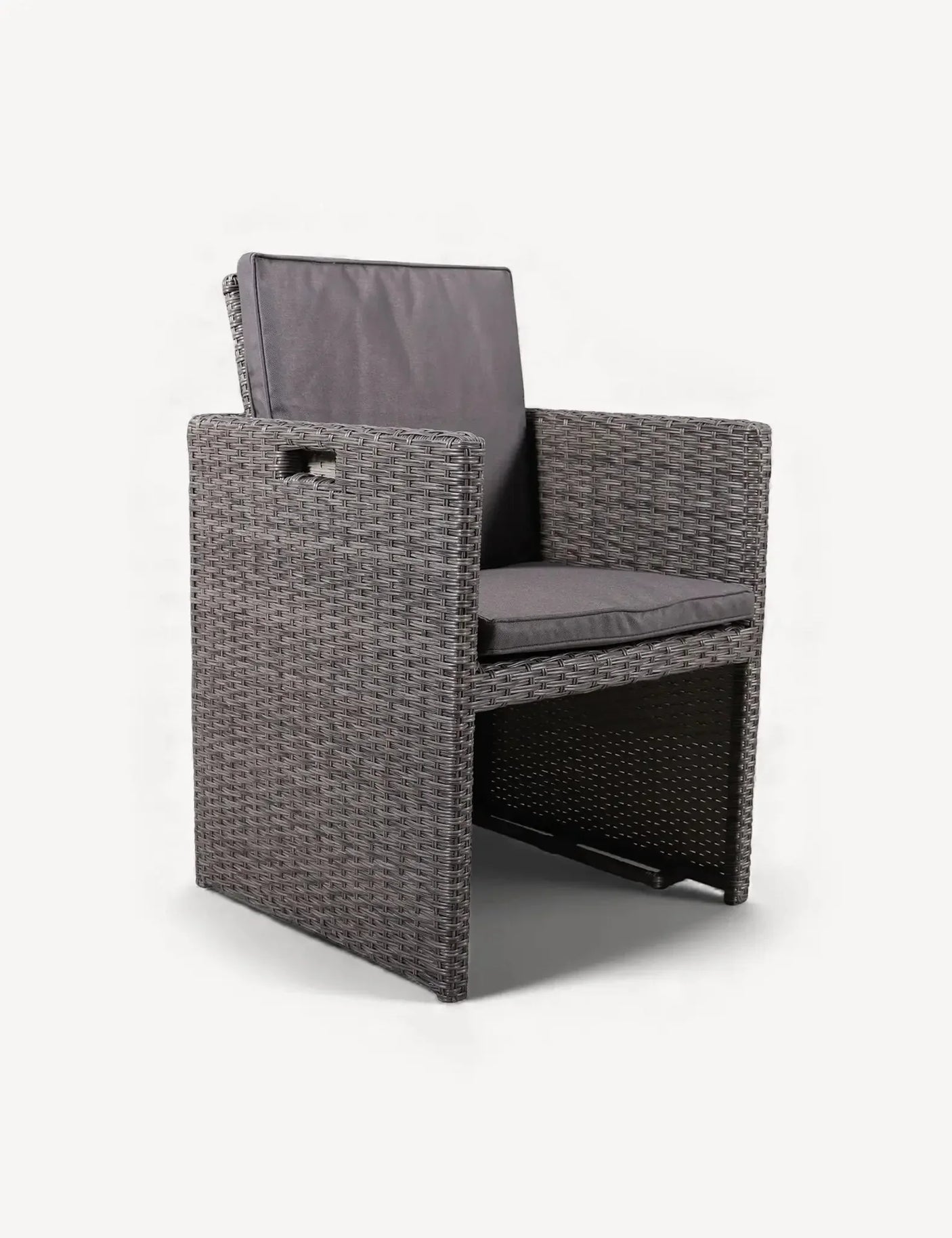 Grey rattan dining chair with armrests and dark seat cushions on white background