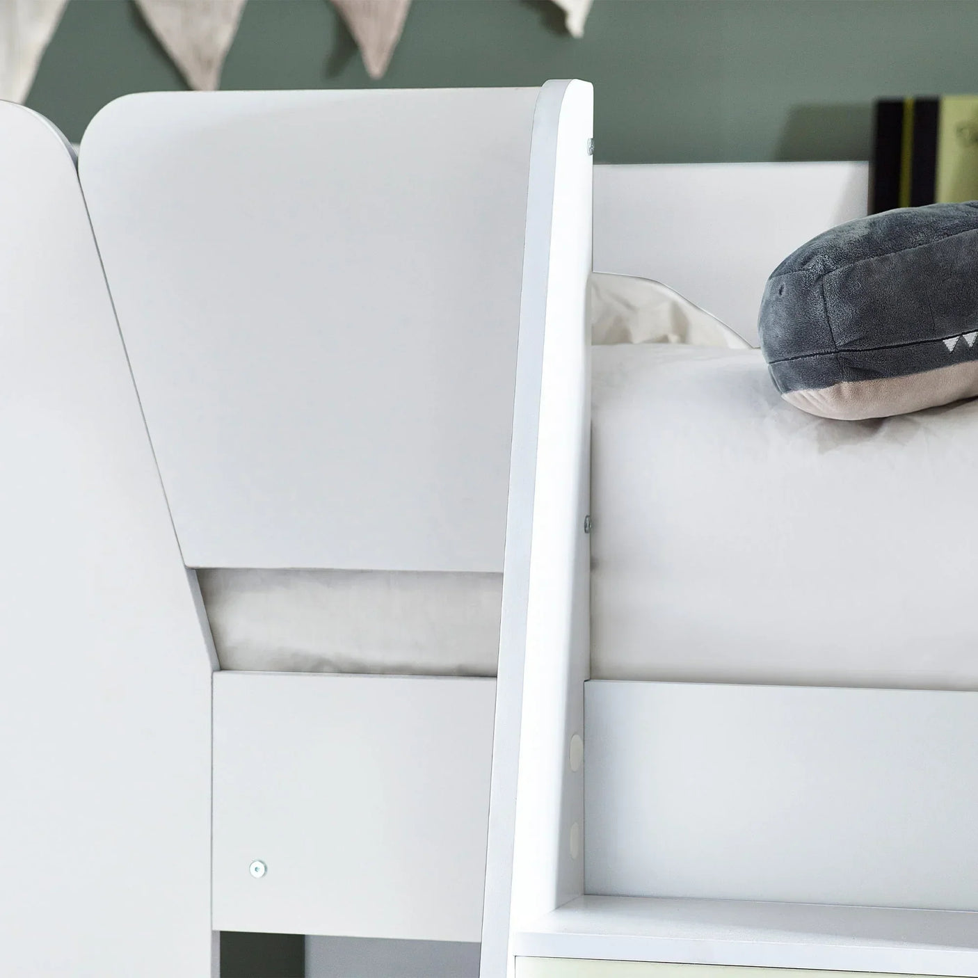 White bunk bed detail showing guard rail, side panel and plush cushion on mattress