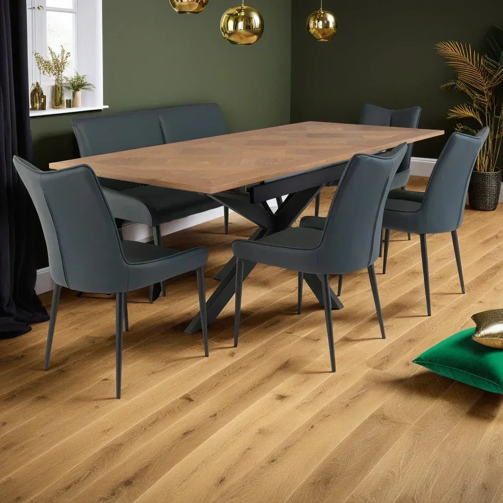 Wood dining table with dark grey chairs and corner bench in modern dining room
