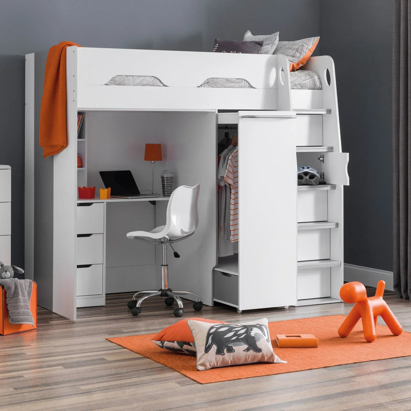 White loft bed with desk, wardrobe, and shelves in a modern children’s bedroom