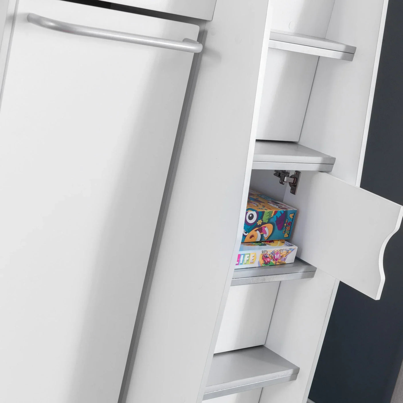 White storage cabinet with open shelves and cupboard showing board games inside