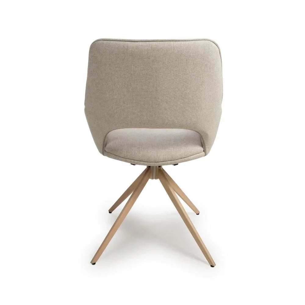 Beige fabric dining chair with curved backrest and angled wooden legs, rear view