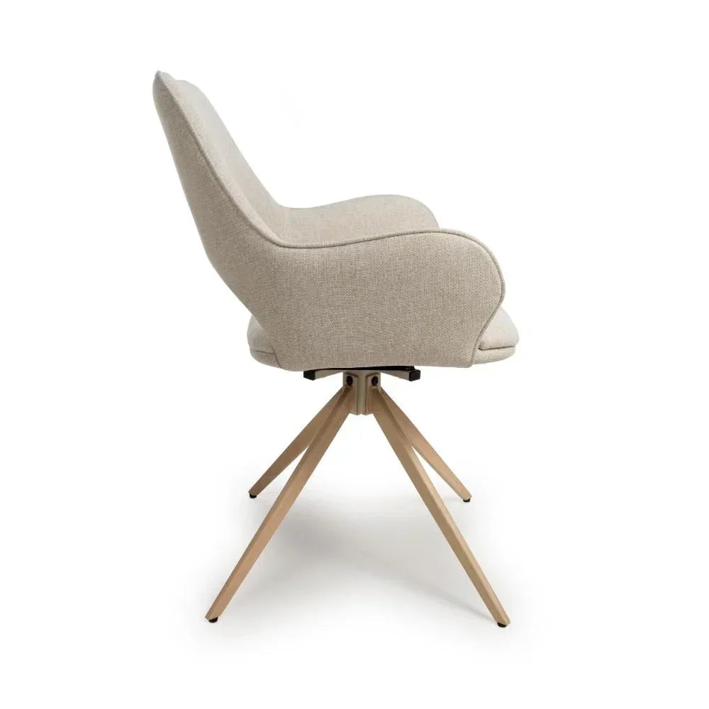 Beige fabric accent chair with curved arms and wooden legs, side profile view