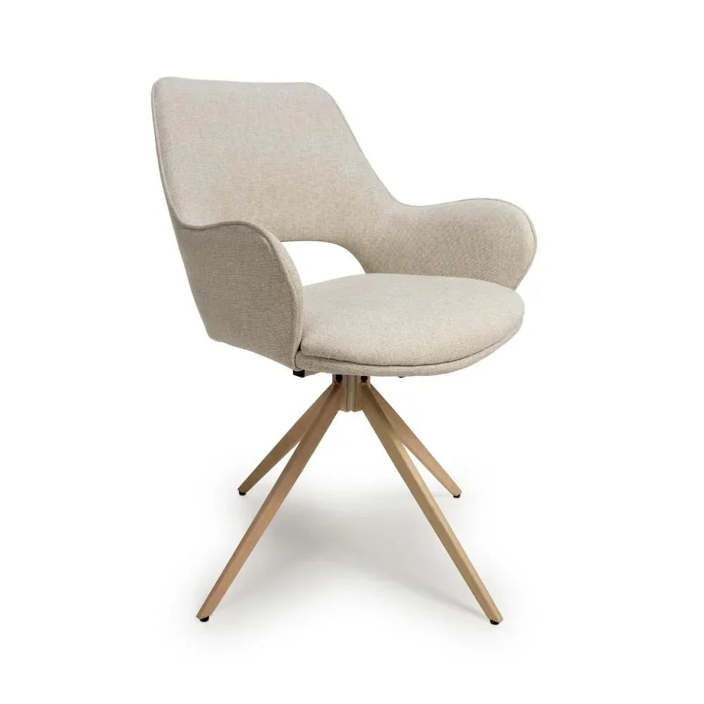 Beige fabric dining chair with curved arms and wooden splayed legs on white background