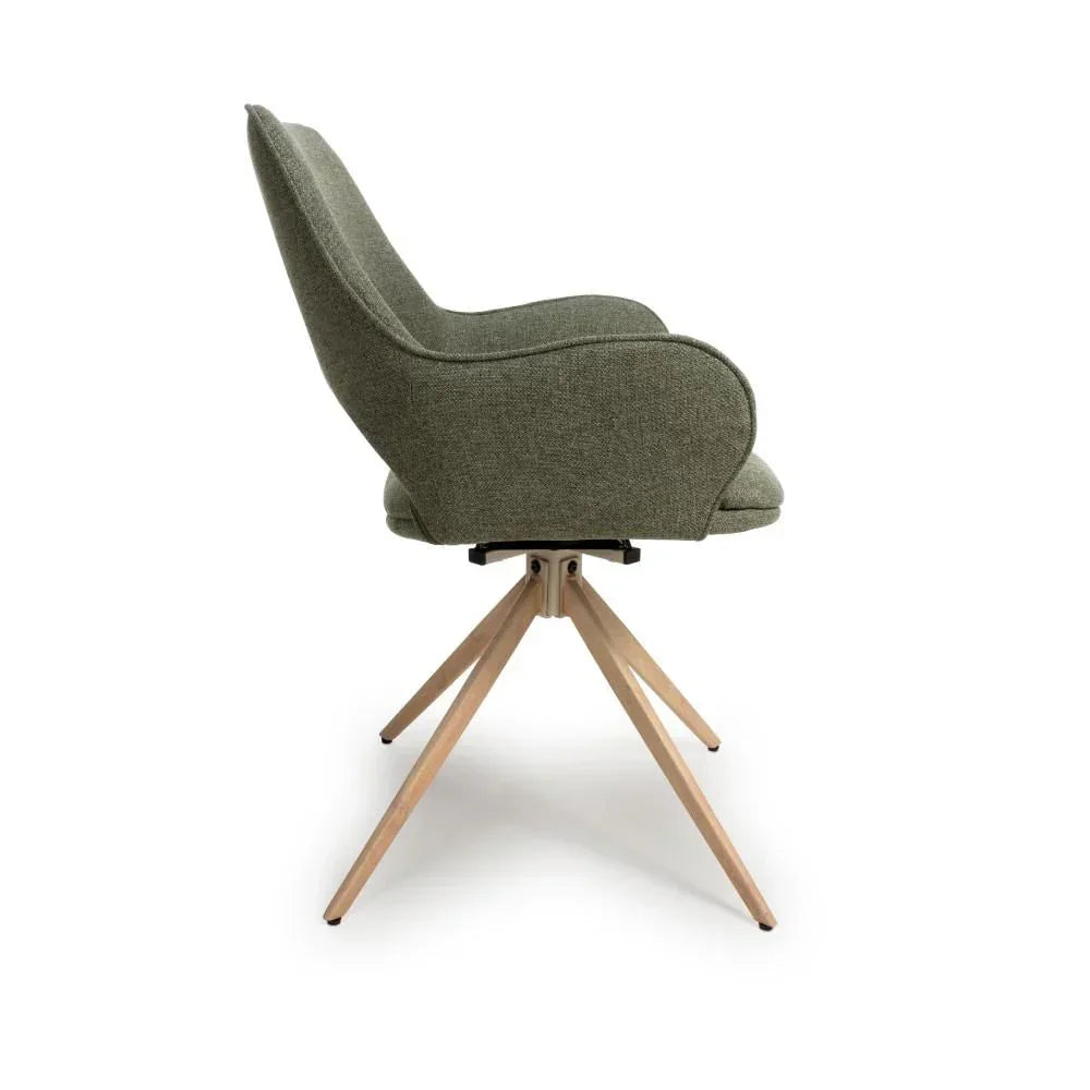 Side view of green upholstered accent chair with wooden legs and curved armrests