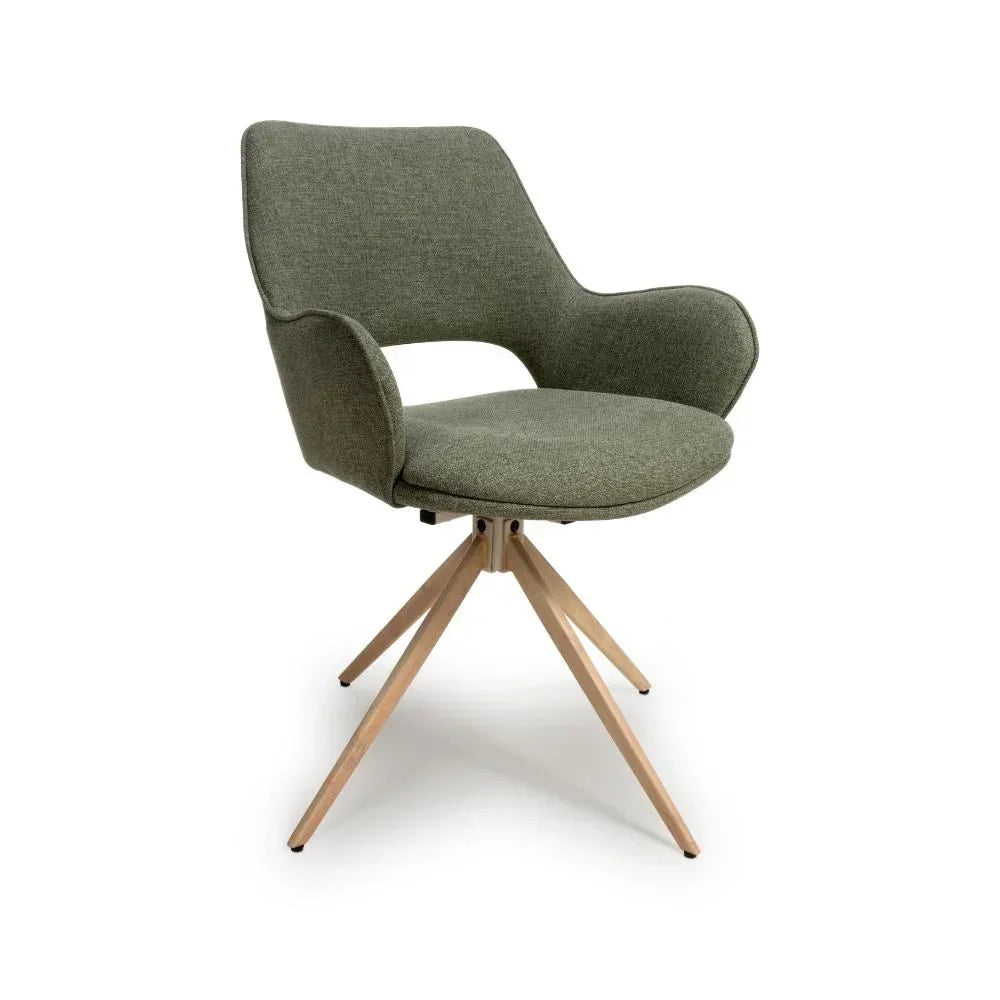 Green fabric dining chair with wooden legs and curved armrests