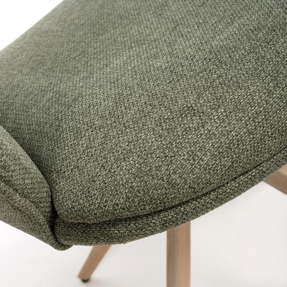 Close view of green fabric dining chair seat with wooden legs