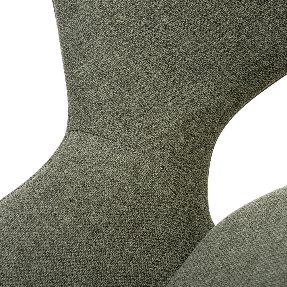 Close-up of textured fabric dining chair backrest in sage green upholstery
