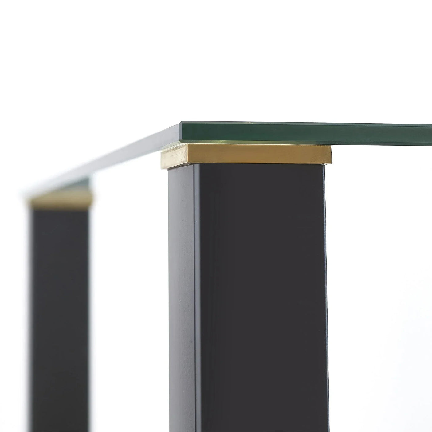 Glass square table top with black legs and gold corner detail closeup