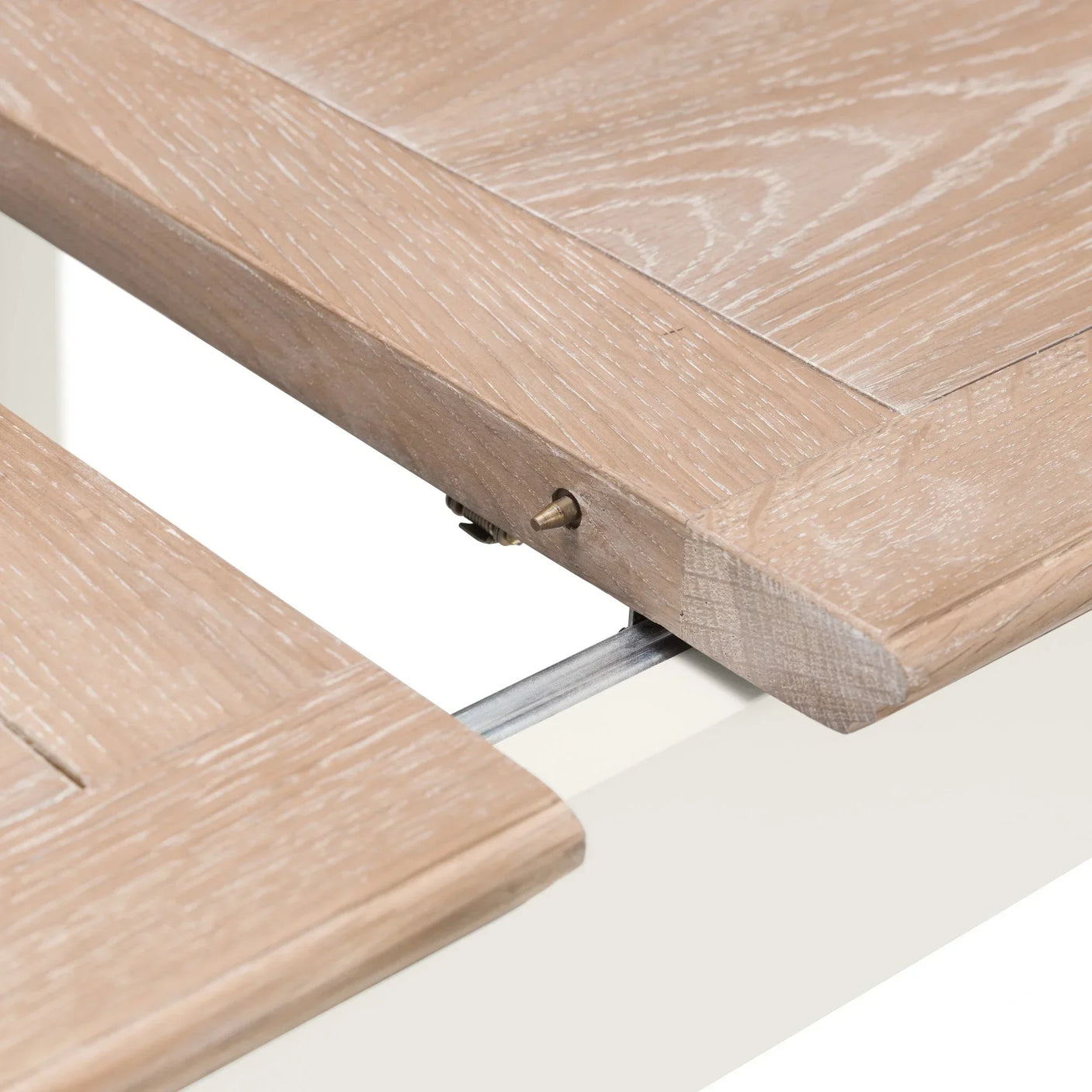 Light oak extending dining table with visible extension mechanism and wood grain detail
